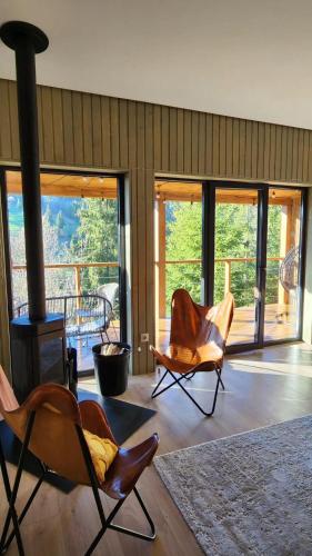 a living room with chairs and a wood stove at Над фермою in Nizhne-Studënyy