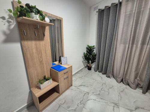 a room with a stand with potted plants on it at 3BR Family Stay Near Valletta in Hamrun