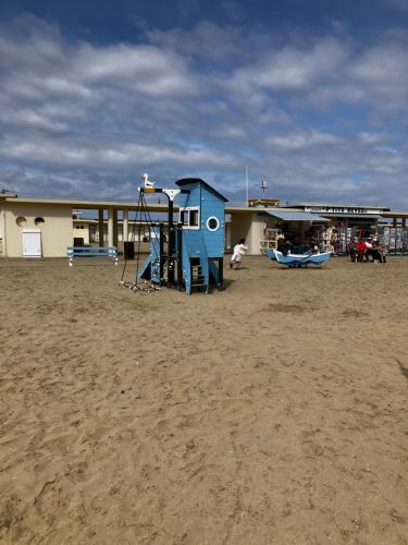 a playground in front of a building at Trouville Palace Le Bonheur in Trouville-sur-Mer