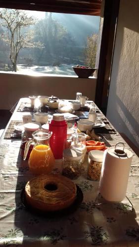 a table with food on it with a window at Pousada Recanto da Pantera in Cunha