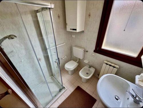 a bathroom with a shower and a toilet and a sink at Holiday home in Rosolina 43925 in Rosolina