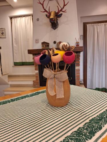 a vase filled with hats sitting on top of a table at B&B La Soldanella in Santo Stefano dʼAveto