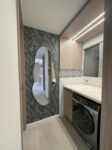 a bathroom with a sink and a washing machine at Open Floor Chic Interior Design Pool Full Kitchen in Barranquilla