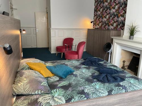 a bed with pillows on it in a room at Hotel Poseidon in Scheveningen