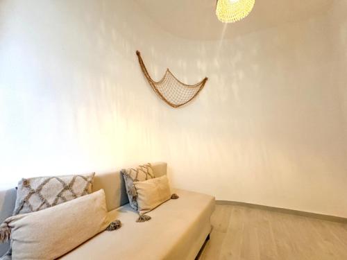 a couch in a living room with a chandelier at Kalma Lux - Sant Efisio Lofts in Cagliari