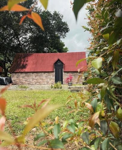 a barn with a red roof in a field at El descanso verde in San Carlos