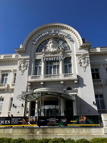 a building with a sign on the front of it at Trouville Palace Le Bonheur in Trouville-sur-Mer