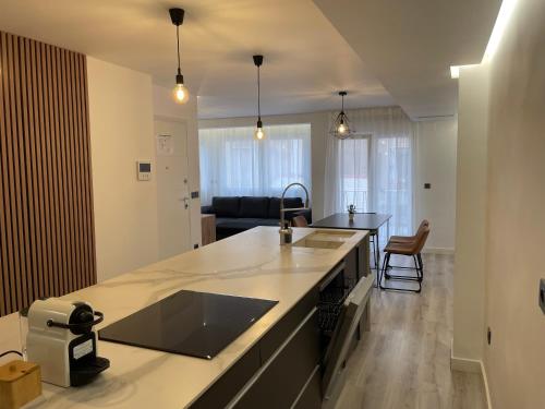 a kitchen with a counter top and a living room at Alicante City Suite 2 in Alicante