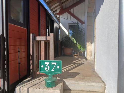 a green address sign in front of a building at Le Tacot in Auxon-Dessus