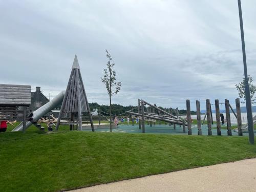 a playground with a slide in a park at Our Salad Days Lochgilphead in Lochgilphead