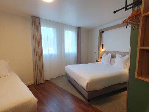 a hotel room with a bed and a window at Best Western Kobalt Annecy Nord - Epagny in Épagny