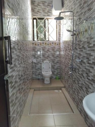 a bathroom with a toilet and a sink at Sweetland view hotel in Lushoto