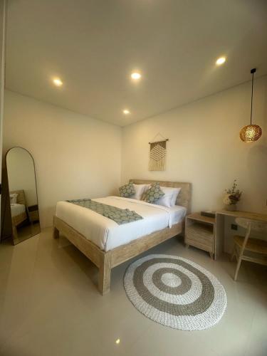 a bedroom with a bed and a rug at Stylish Villa, 2BR ,GREAT VALUE, Great Location ! in Uluwatu
