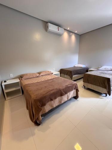 a room with two beds in a room at Casa Alter do Sol - 3 suites in Alter do Chao