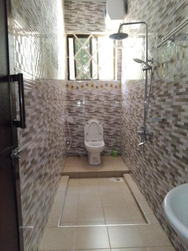a bathroom with a toilet and a sink at Sweetland view hotel in Lushoto