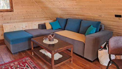 a blue couch in a room with a table at Brvnara Topilo in Niš