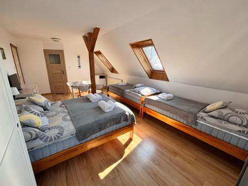 a bedroom with two beds in a room at Kwatery u Szymka in Jastarnia