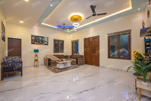 a living room with a marble floor and a ceiling at Sea Shell By The Sea Luxurious Villa 3min From Awas Beach Surrounded By Mango Trees in Alibaug