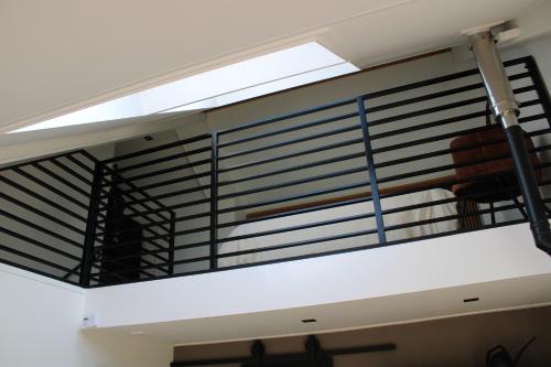 a staircase in a room with black metal railings at Hof van Kooij in Groessen