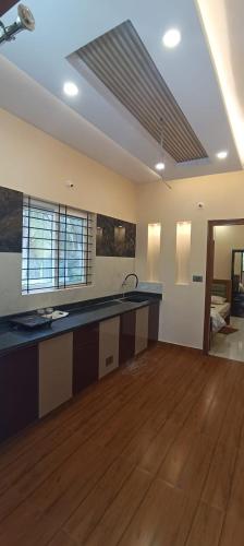 a large kitchen with a sink and a counter top at G3 nest in Mysore
