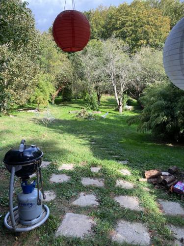 a garden with a grill and a red lantern at Bienenhaus Van Sonnensee in Ritzing