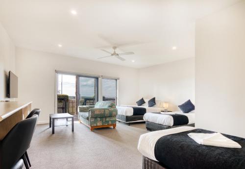 a hotel room with two beds and a living room at Inverloch Motel in Inverloch