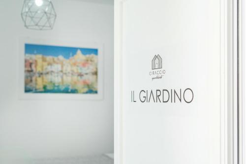 a door with a sign that reads i gardening and a picture at Ciraccio Apartments in Procida