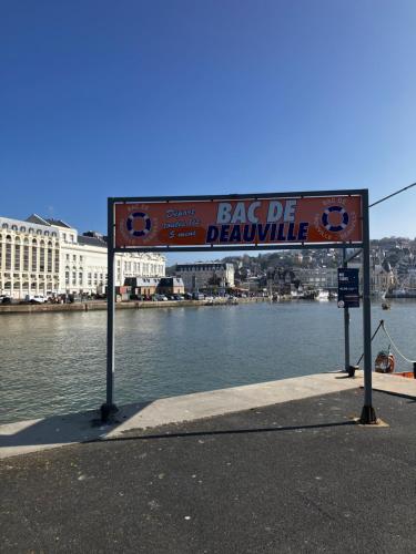 a sign on the side of a body of water at Trouville Palace Le Bonheur in Trouville-sur-Mer