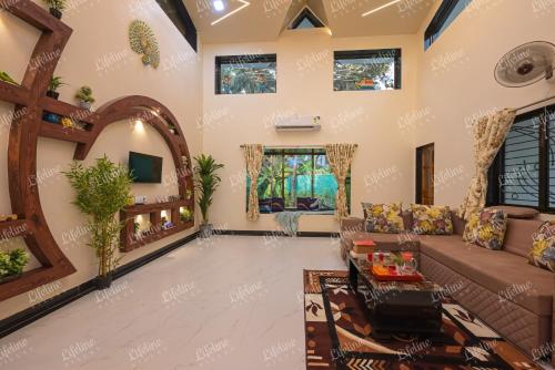 a living room with a couch and a table at SEAs THE DAY LUXURIOUS 5BHK VILLA 2min From Awas Beach With Huge Private Pool in Alibaug