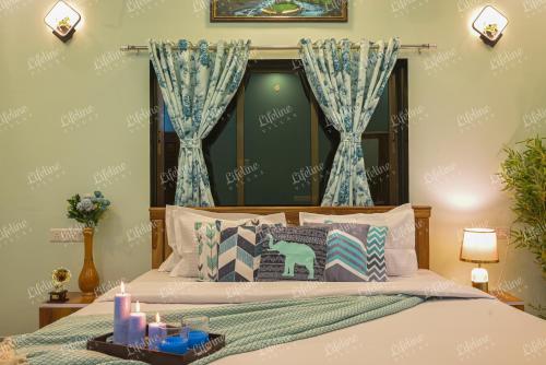 a bedroom with a bed with candles on it at SEAs THE DAY LUXURIOUS 5BHK VILLA 2min From Awas Beach With Huge Private Pool in Alibaug