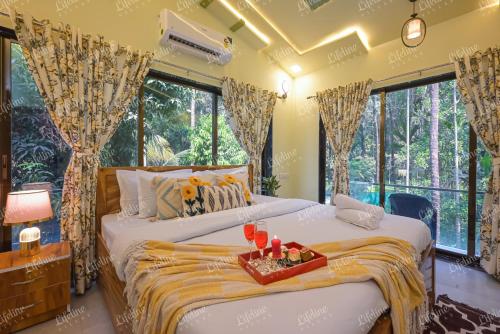 a bedroom with two beds and large windows at SEAs THE DAY LUXURIOUS 5BHK VILLA 2min From Awas Beach With Huge Private Pool in Alibaug