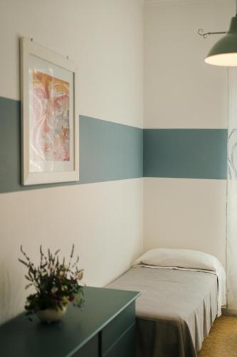 a bedroom with a bed and a table with a plant at Ciraccio Apartments in Procida