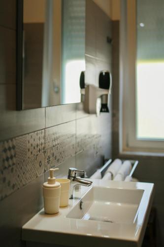 a bathroom with a white sink and a mirror at Ciraccio Apartments in Procida