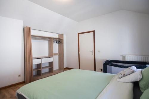 a small bedroom with a bed and a mirror at Maison du Doudou centre ville in Mons