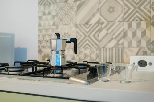 a blender sitting on top of a stove at Ciraccio Apartments in Procida