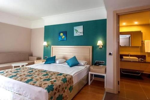 a bedroom with a large bed and a green wall at Linda Sunny Beach Hotel & Spa-Ultra All Inclusive in Side
