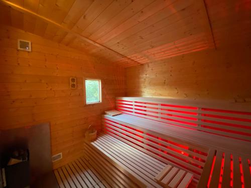 a room with a red bench in a wooden room at Agriturismo il fragolino in Bassano Romano