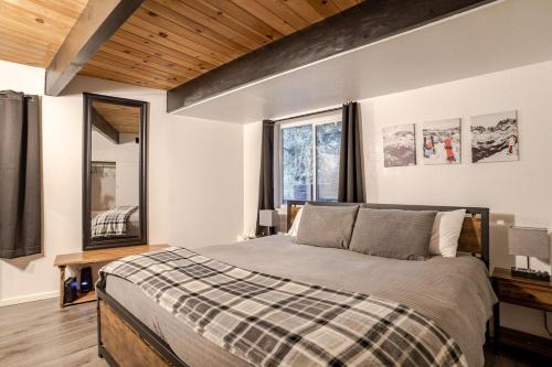a bedroom with a bed and a large window at Snow Valley Retreat With Spa in Running Springs