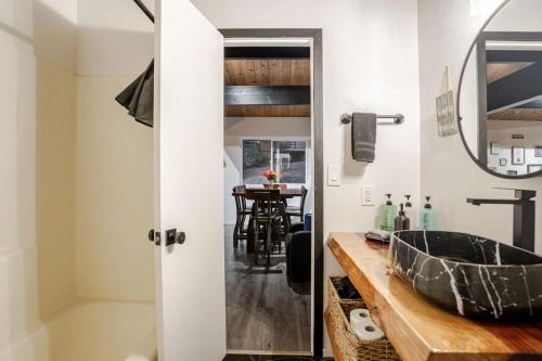 a bathroom with a sink and a mirror at Snow Valley Retreat With Spa in Running Springs