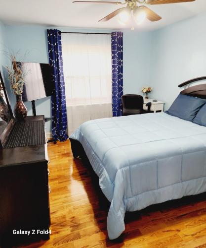 a bedroom with a bed and a chair and a window at Cozy 1 Bedroom Business Suite in Philadelphia