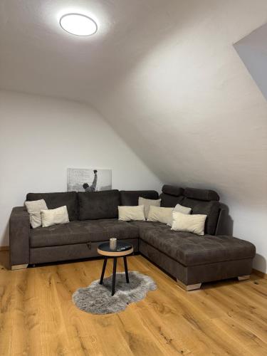 a living room with a couch and a table at Pure Living in Losheim