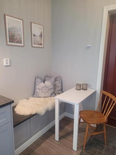 a room with a bench with a table and a chair at Trevlig lägenhet på landet in Örebro