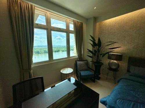 a bedroom with a large window with a view of the water at Wind Homestay Riverine Diamond in Kuching