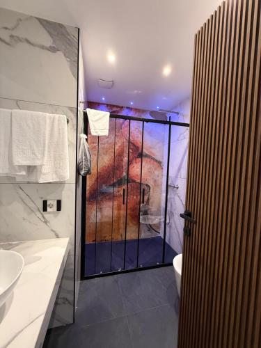 a bathroom with a shower and a toilet and a sink at Positano Art Hotel Pasitea in Positano