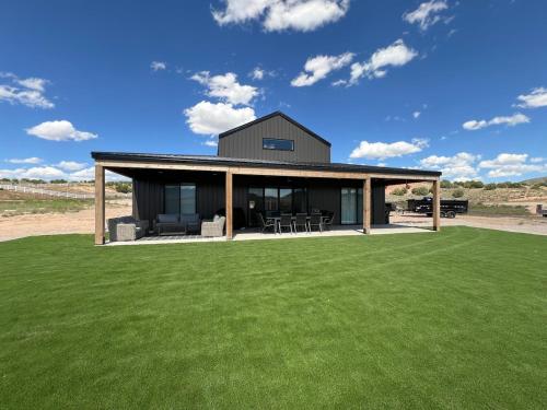 a house with a large yard with green grass at Yuba Lake Barndominium Resort in Levan