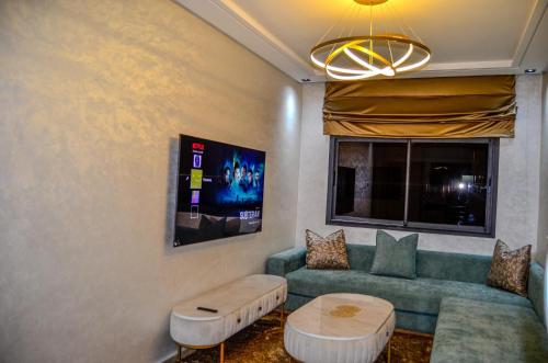 a living room with a green couch and a window at Deluxe apartment - Banana Beach in Aourir