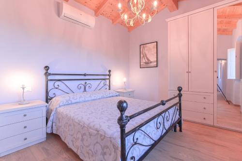 a bedroom with a bed and a chandelier at Le Rocce Wellness and Fitness, only adults in Lerici