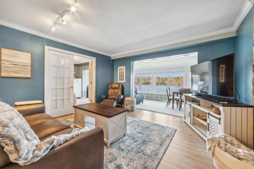 a living room with a couch and a tv at Condo with Panoramic views on Clam Lake in Bellaire