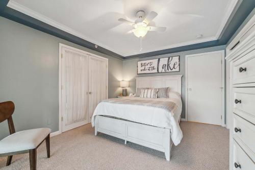 a bedroom with a bed and a ceiling fan at Condo with Panoramic views on Clam Lake in Bellaire