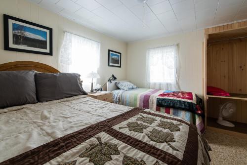 a bedroom with two twin beds and a window at Out East B&B - Norris Point in Norris Point